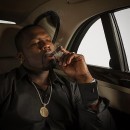 50 Cent posing in his cars for an ad