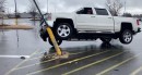 Chevy Silverado stuck up a pole finds release, and driver gets a face full of airbag