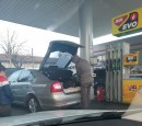 Man getting extra gas in small bottles