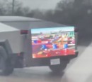 Tesla Cybertruck carrying a TV which was on