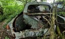 classic car junkyard at abandoned farmhouse