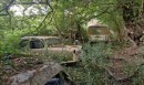 classic car junkyard at abandoned farmhouse