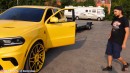 Yellow Dodge Durango SRT Hellcat rides on matching-yellow 26-inch Forgiatos when towing Lambo Aventador Roadster