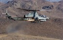Attack helicopter firing JAGM and Hellfire missiles