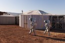 analog astronauts in their Aouda space suit simulators are seen in front of the crew’s Mars habitat in the Ramon Crater in Israel