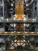 NASA's team lifting the 212-foot-tall SLS rocket's core stage and its four RS-25 engines to the mobile launcher to place it in between smaller boosters