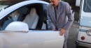 Sacha Baron Cohen in character as Borat, drives mail truck into Tesla Model X