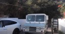 Sacha Baron Cohen in character as Borat, drives mail truck into Tesla Model X