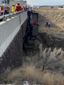 Couple crashes Ford F-350 and trucks dangles from a bridge in Idaho