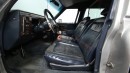 The Cadillac Brougham lifted hearse sits on a Chevy K10 chassis, commands all the attention