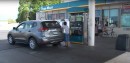 Woman Filling Up Her SUV