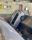 Car drives straight into trash compactor