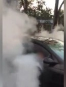 Five-year-old kid doing a burnout in driveway