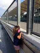 Ally wearing hearing protection watching his father Casey Stoner testing Honda bikes at Sepang, 2015