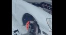 C6 Chevrolet Corvette with exposed engine has skis and tracks for winter fun