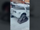 C6 Chevrolet Corvette with exposed engine has skis and tracks for winter fun