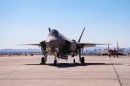 An F-35A Lighting II carrying a B61-12 nuclear gravity bomb sits on the flight line at Nellis Air Force Base, Nevada