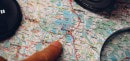 Finger pointing on a map to the next adventure