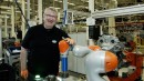 Robbie the Cobot lends Dietmar Brauner, who suffers from reduced mobility, a helping hand