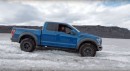 Ford Raptor towed out of snow by a Hilux