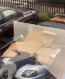 Owner desperately tries to protect his Toyota Supra from the hail, using his body as shield