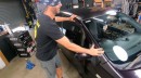 While blindfolded, Moog tries to guess what car Marty bought
