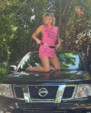 Miley Cyrus on top of her Dad's Nissan