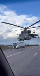 Military Helicopter Flying Close to Cars