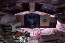Snoopy floating inside the Orion capsule as it moves around the Moon