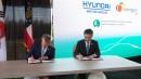 Governor Brian P. Kemp and Hyundai's CEO Jaehoon Chang sign papers while announcing investments in Georgia