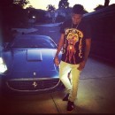 Nick Young next to his ice blue Ferrari California