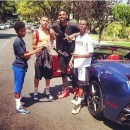 Nick Young next to his ice blue Ferrari California