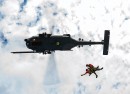 HH-60G Pave Hawk hoisting two pararescuemen