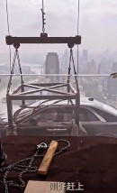 Brand new Rolls-Royce Ghost is craned 44 floors up to be used as static display on the terrace of a condo