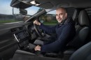 Pep Guardiola poses inside a Nissan Leaf EV