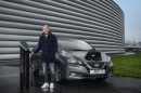Pep Guardiola poses with a Nissan Leaf EV