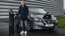 Pep Guardiola poses with a Nissan Leaf EV