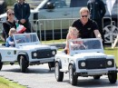 Duke and Duchess of Sussex in electric Mini-Defenders
