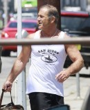 Mel Gibson Flexes his Muscles Next to his BMW