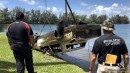 Cars being pulled out of a lake in Doral, Florida