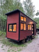 Modest tiny house on wheels with pinewood interiors