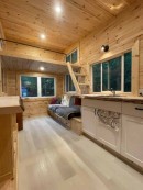 Modest tiny house on wheels with pinewood interiors