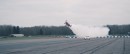 Morgan Aero 8 races a biplane on a runway
