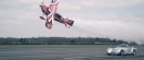 Morgan Aero 8 races a biplane on a runway