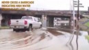 Driver floods pickup truck under a bridge