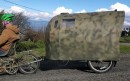 The Nomad is a bicycle camper made from discarded campaign billboards, lightweight and stable