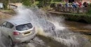 Drivers Speeding Through a Puddle