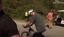 U.S. President Joe Biden falls off his Trek bike as he pulls over to chat with supporters