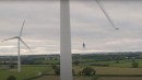 Danny MacAskill rides his bike on the blade of a wind turbine