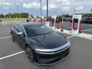 Lucid Air at a Tesla Supercharger